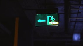 Exit icon, close-up. Direction to the emergency exit. a green light sign indicating the direction of movement to the emergency exit in the room. green emergency exit sign above a door in a interior. - Powered by Shutterstock - Get 15% off with code: PIKWIZARD15