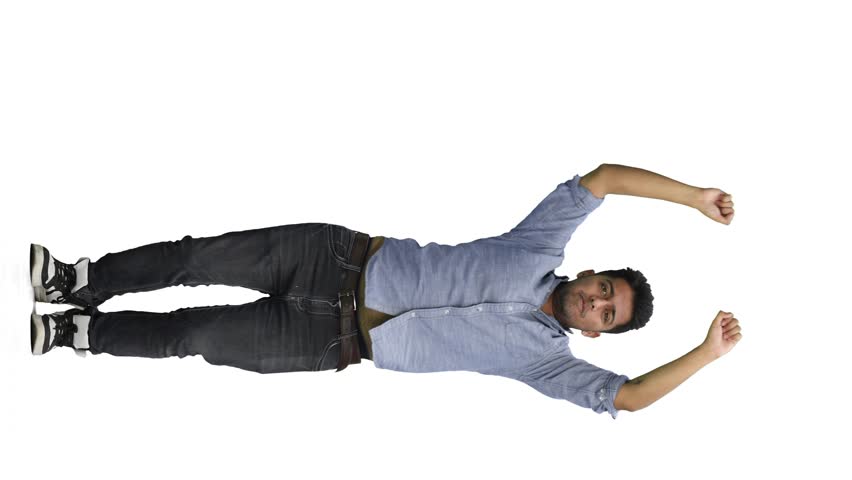 A man in a blue shirt on a white background jumps up and waves his arms above himself