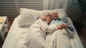 Happy senior couple sleeping in bed embraced, close relationship, strong bond - Powered by Shutterstock - Get 15% off with code: PIKWIZARD15
