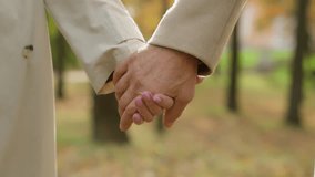 Close up holding hands couple together in park outdoors middle aged partners two male female grandparents hold palms elderly family wrinkled hand woman man unity support in retirement love at old age - Powered by Shutterstock - Get 15% off with code: PIKWIZARD15