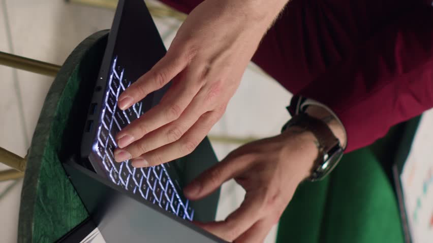 Vertical Video Business manager reviews papers at hotel, waiting to check in. Entrepreneur travelling for important executive conference, trying to forge new multinational partnership. Handheld shot.