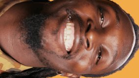 Vertical Video POV of african american guy looks at his reflection in the mirror, arranging his beard and dreads to be confident and trendy. Modern adult is looking at himself and feeling good. Tripod - Powered by Shutterstock - Get 15% off with code: PIKWIZARD15