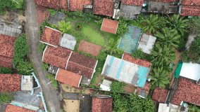 Phu Yen, Vietnam - Dec 26th, 2023 4k aerial video of House with red roof at Dong Hoa fishing village during windy morning