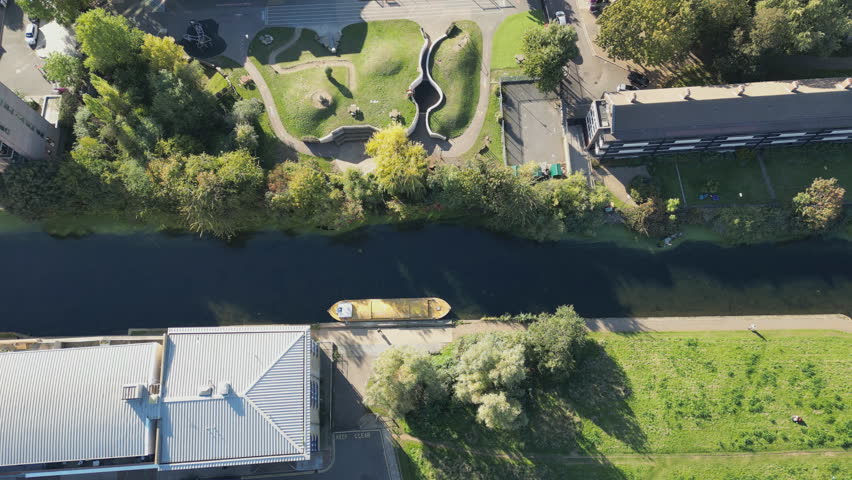 A high angle view of a canal with greenery in a city.