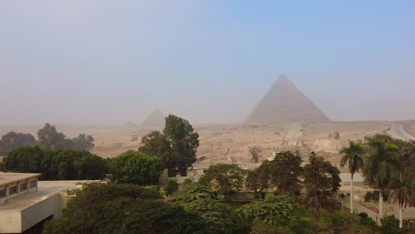 Cairo, Egypt: Panoramic view of the famous Great Pyramids of Egypt and the Sphinx in Giza in the desert at the limit of Cairo city. 