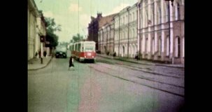 Tram stop in old town center in sunny summer. Beautiful architecture of Europe city. Wide street at 4k footage. Avenue landscape. Roadway in cityscape. Vintage color archive film. Retro 1980s, Russia
