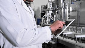 Factory worker inspecting production line on beverage factory with computer tablet. High quality 4k footage - Powered by Shutterstock - Get 15% off with code: PIKWIZARD15