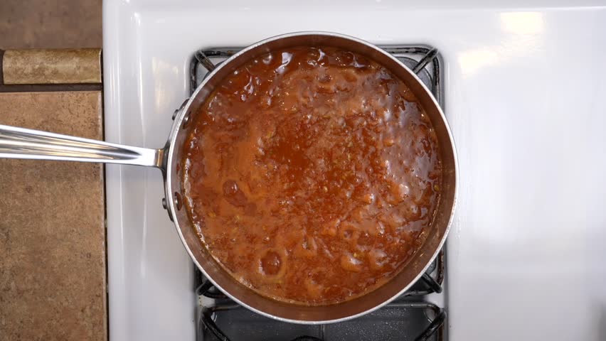 Top down down view of sauce simmering on the stove - chana masala series Royalty-Free Stock Footage #3405152315