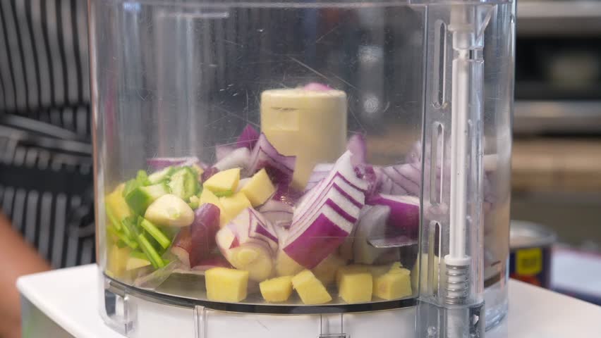Chopping and mixing red onion, pepper, cilantro, garlic and other ingredients in a food processor - Chana Masala series