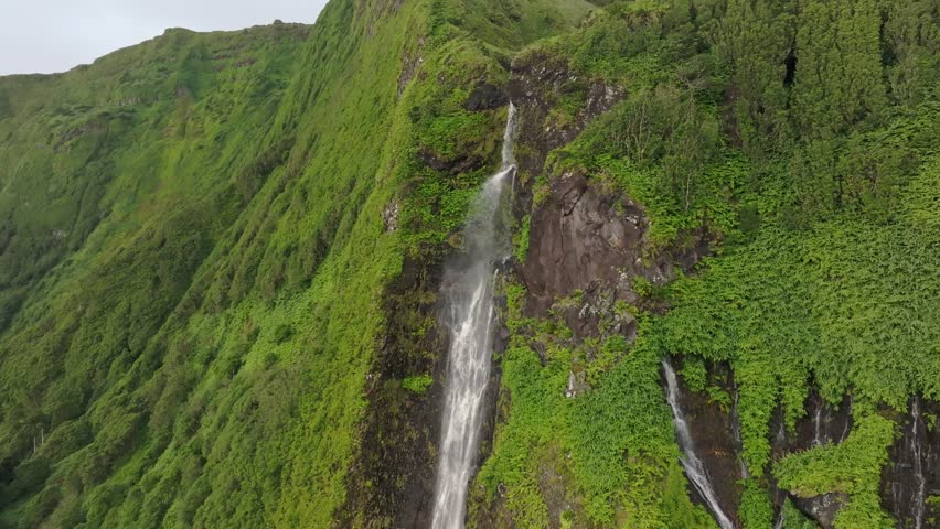 Magical powerfull Poço Ribeira do Ferreiro waterfall at Azores - Drone shot