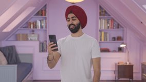 Happy Sikh Indian man talking on video call