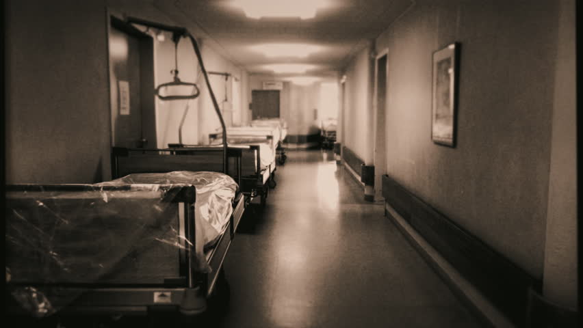 Empty Hospital Beds Corridor Walk Through Old Vintage Film Effect Tracking Shot. Camera walking through an empty hospital corridor, old vintage style. Tracking shot Royalty-Free Stock Footage #3405199565