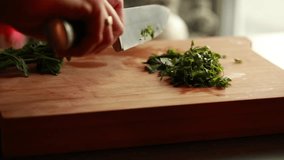 Close-Up Woman's Hands Chopping Parsley on Wooden Board
