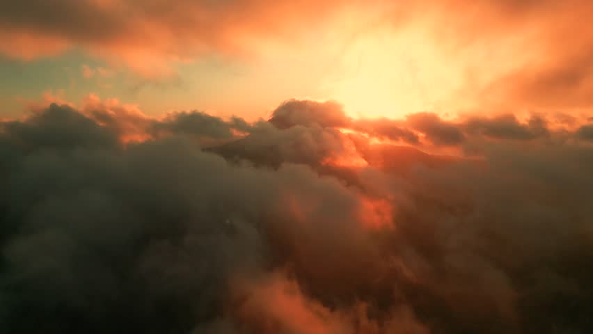 Aerial view of Sunrise over the clouds epic and amazing sky on volcano.