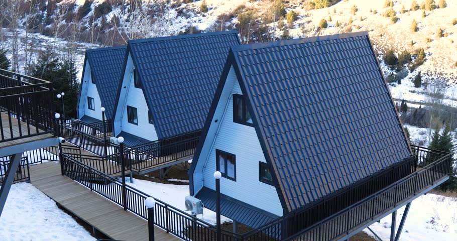 A Frame cabins on hill in the winter park