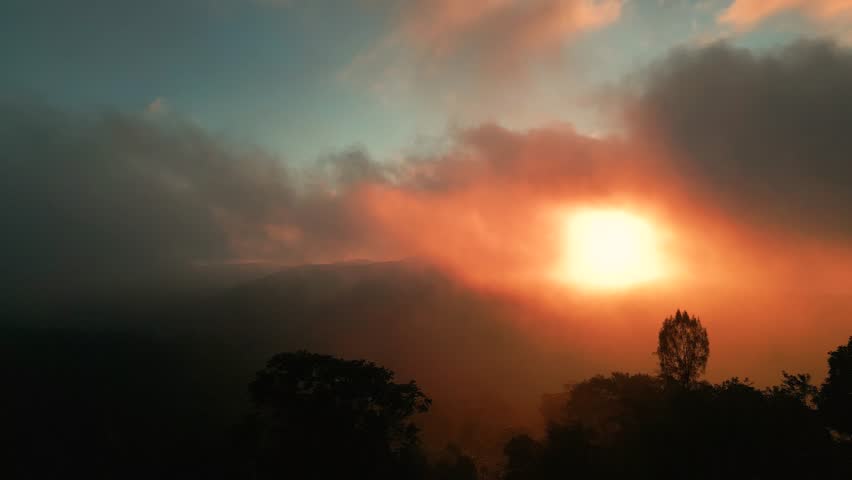 Aerial view on Spectacular sunset above the clouds on volcano.