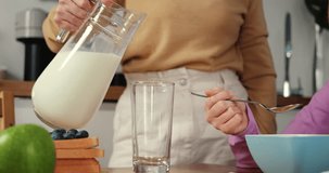Cinematic close-up of milk pouring symbolizing parental care milk key to natural ingredients breakfast milk in morning routine serene atmosphere. Ad clip with milk natural ingredients.
