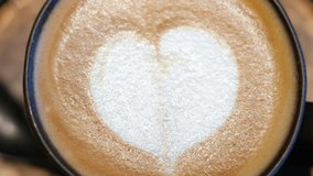 Brown cappuccino close up with white heart on top at a coffee shop - Powered by Shutterstock - Get 15% off with code: PIKWIZARD15
