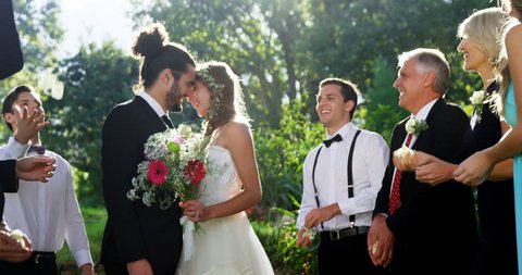 Guests toss petals while bride and groom kissing at wedding 4K 4k