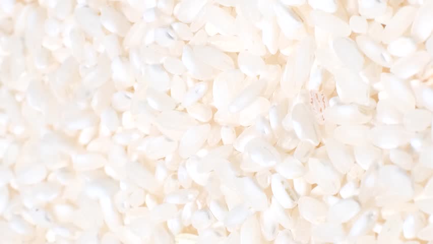 Macro video of rice grains rotating in a circle. Asian food. Vertical video