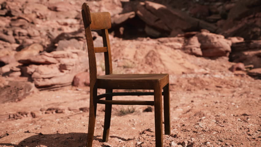 old wooden chair on rocks of Grand Canyon