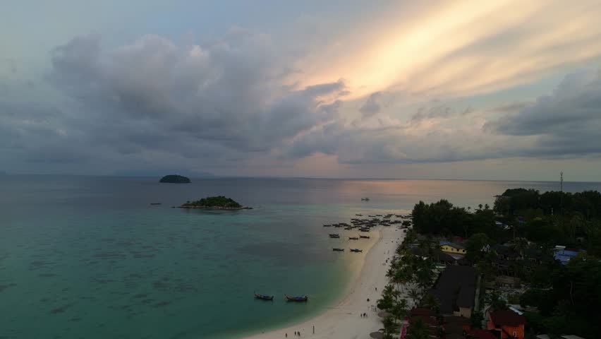Koh Lipe, Thailand: Aerial drone footage of the sunset over the Zodiac beach with its new resort in the Koh Lipe island in the Andaman sea in southern Thailand Royalty-Free Stock Footage #3405712549