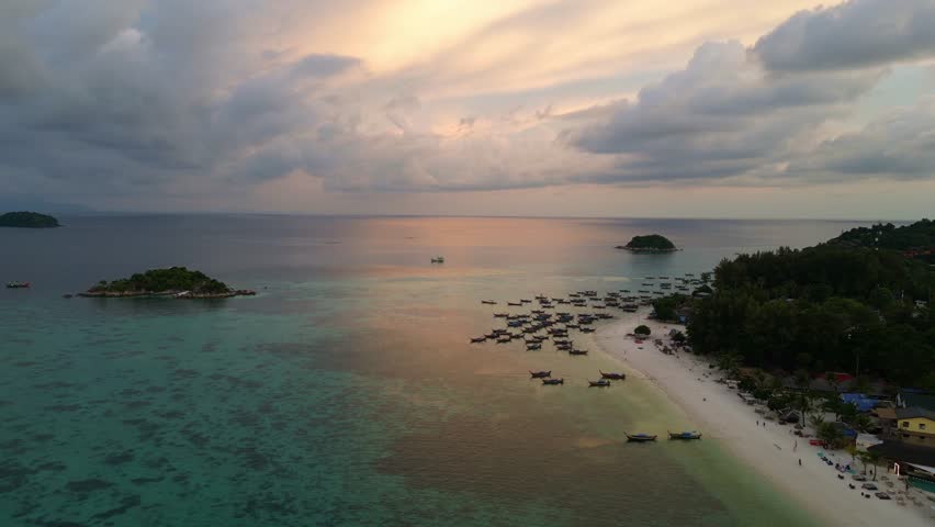Koh Lipe, Thailand: Aerial drone footage of the sunset over the Zodiac beach with its new resort in the Koh Lipe island in the Andaman sea in southern Thailand Royalty-Free Stock Footage #3405716843