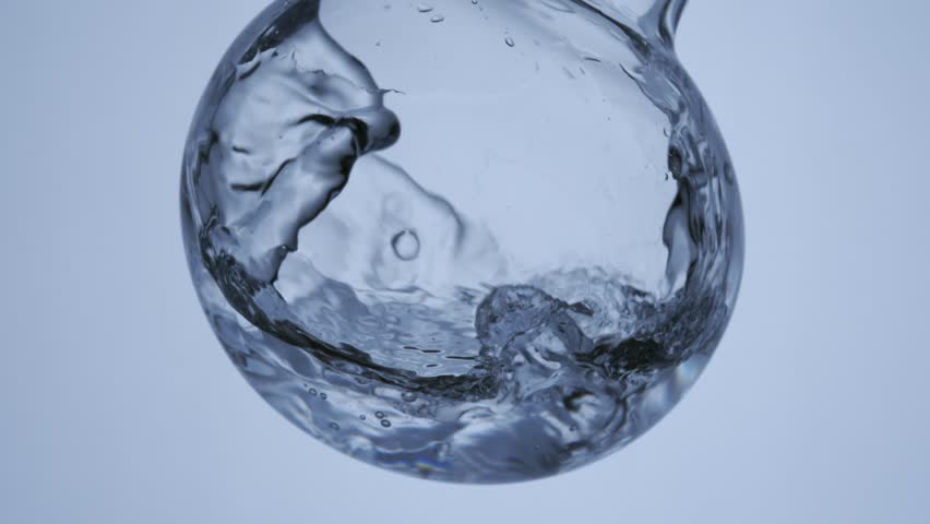 shaking glass lab ware test tube Erlenmeyer flask with water liquid in it. scientific research Skin care concept. Slow motion. 