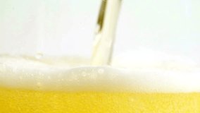 Low angle of foamy beer filling glass cup in slow motion on black background. Light beer pouring in glass. With bubbles and foam. nightclub concept - Powered by Shutterstock - Get 15% off with code: PIKWIZARD15