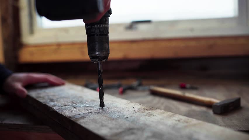 Power Drill Drilling Hole On Wood - Carpentry Concept. - close up shot