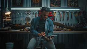 African American carpenter, artisan uses tablet computer, then turns around and starts working on wood products. Tree branch and board with professional tools in modern stylish woodworking workshop. - Powered by Shutterstock - Get 15% off with code: PIKWIZARD15