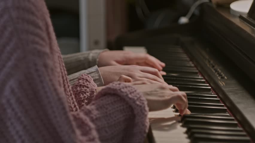Closeup view of two girls learning to play piano Royalty-Free Stock Footage #3405834001