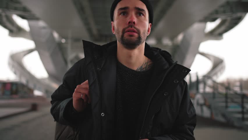 Man walk on street using navigation map. Bearded male with backpack looking at phone screen to find new street in unknown city. Using smartphone for orientation, modern technologies in usual life.