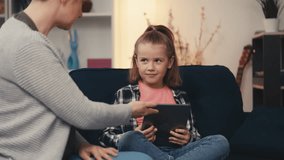 Upset mother struggles to take a gadget away from misbehaving little daughter - Powered by Shutterstock - Get 15% off with code: PIKWIZARD15