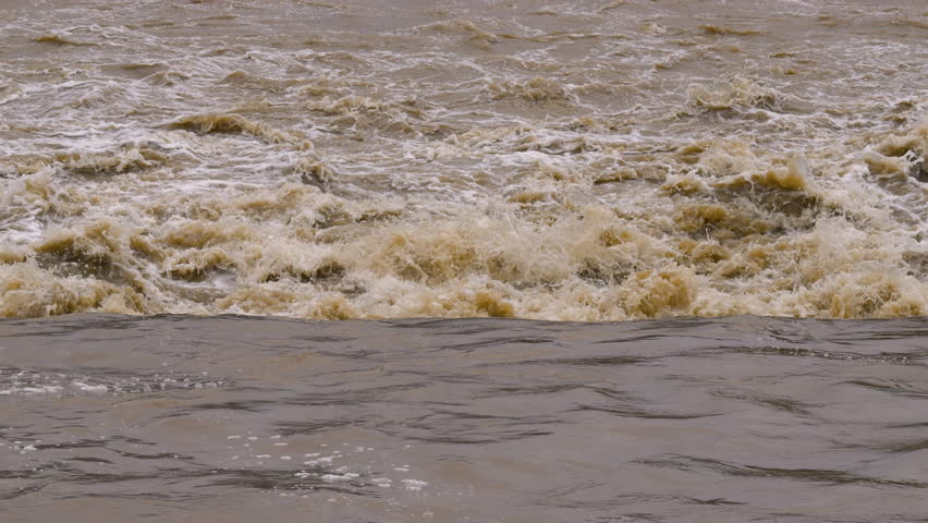 Footage of muddy and blurry flowing stream after rain and storm. Royalty-Free Stock Footage #3406055561