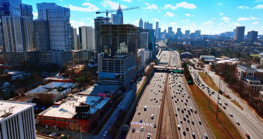 Lively traffic on the highways of Atlanta at daytime. Scenery of the city downtown from top on sunny fall day.
