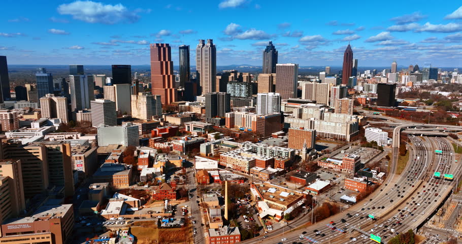 Flight above the low-rise and high-rise architecture of American city. Approaching skyscrapers in Atlanta downtown.