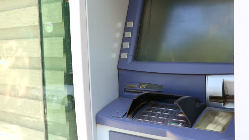 Broken dusty out of service ATM machine on the street