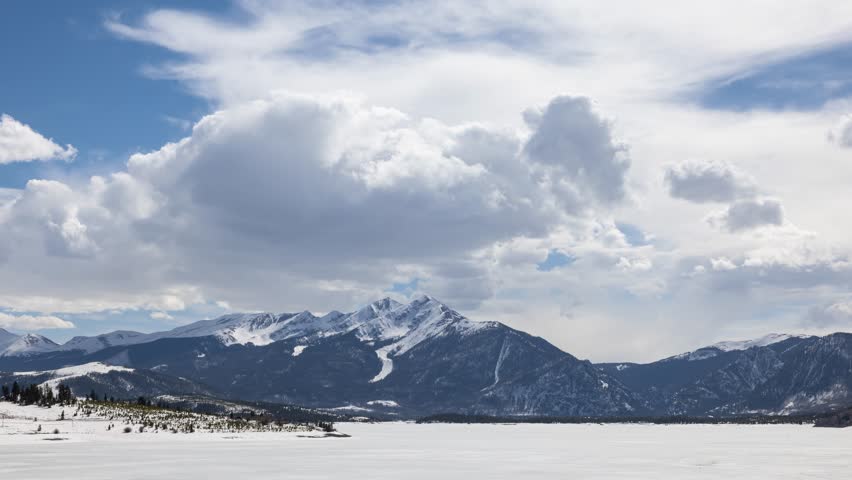 Time Lapse of the clouds moving above the Rocky Mountains near the town of Silverthorne Colorado USA. Dillon Reservoir in the foreground.