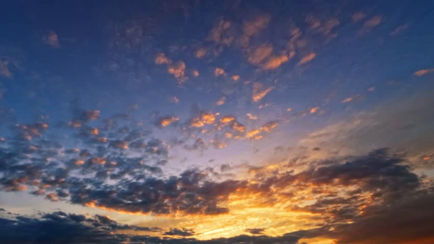 timelapse - goldish sunrise scene with fluffy clouds - loop video Royalty-Free Stock Footage #3406283903