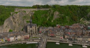 Establishing aerial shot of Dinant, Belgium drone cinematic video. Beautiful Belgian city on the river bank. Summer time in the tourist center of Dinant
