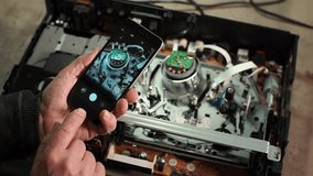 electronics repair. take a photo with your smartphone. smartphone close-up. take a photo of the part with your smartphone. Slow motion video. Repair of consumer electronics. High quality video in 4k