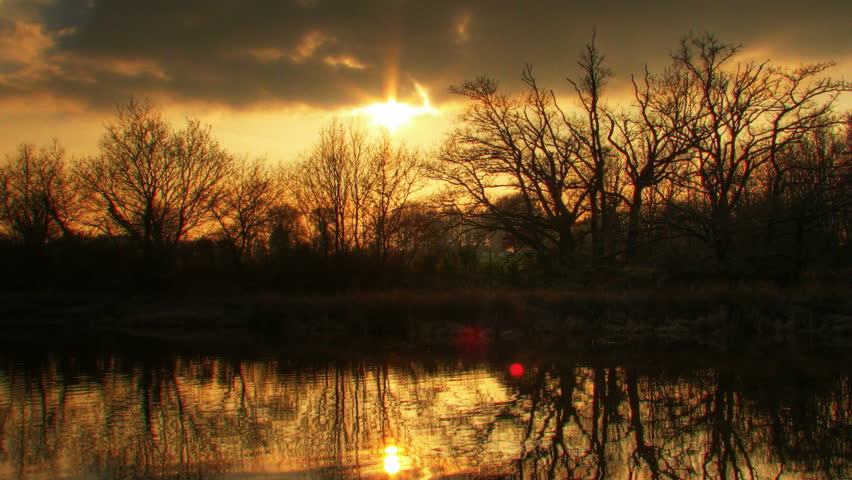 Sunset over water, HD time lapse clip, high dynamic range imaging