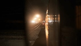 Illuminated railway station and arriving trains on platform in night time - Powered by Shutterstock - Get 15% off with code: PIKWIZARD15