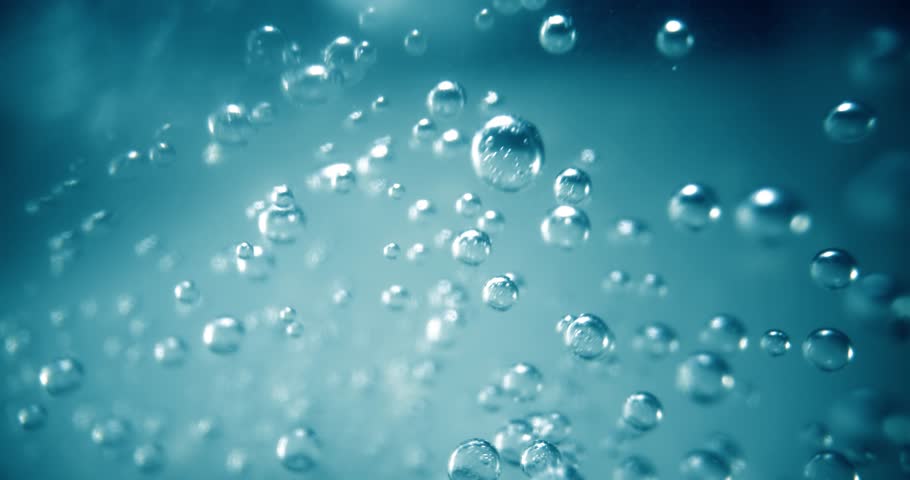 Many water bubbles in blue water close up, abstract water wave with bubbles in slow motion.