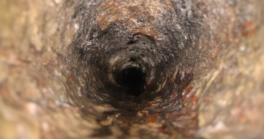 sliding inside old dirty and rusty cast iron sewer line pipe Royalty-Free Stock Footage #3406509135