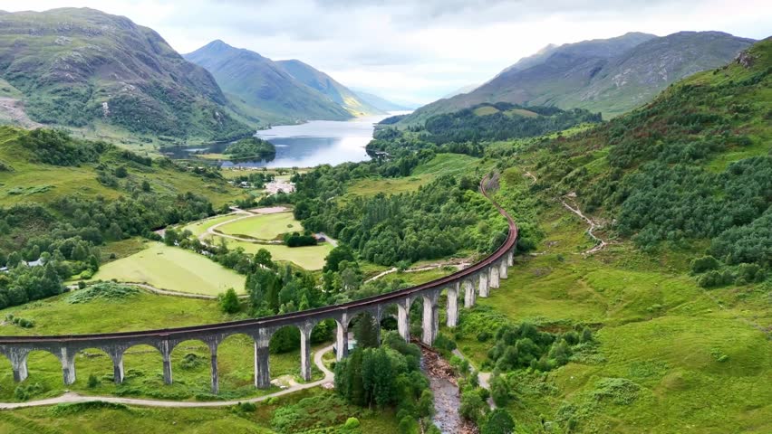 Drone Scotland 4k. Aerial view Glenfinnan viaduct bridge, on which famous Jacobite train runs in Scotland. Jacobite Railway scenic tourism attraction in Britain. 