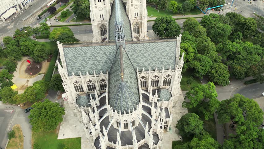 Vienna's Votivkirche in sunrise's embrace Aerial view unveils the neo Gothic beauty amid the skyline, adorning the Ringstrasse in Austria's captivating capital at Votivpark