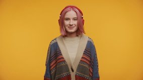 Waving Teenager with Headphones and Pink Hair