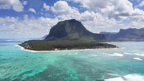Turquoise clean lagoons protected by coral reefs of Le Morne peninsula with basalt mount on Mauritius island. Also a wonderful kiteboarding and windsurfing spot. Exotic traveling aerial 4K video.